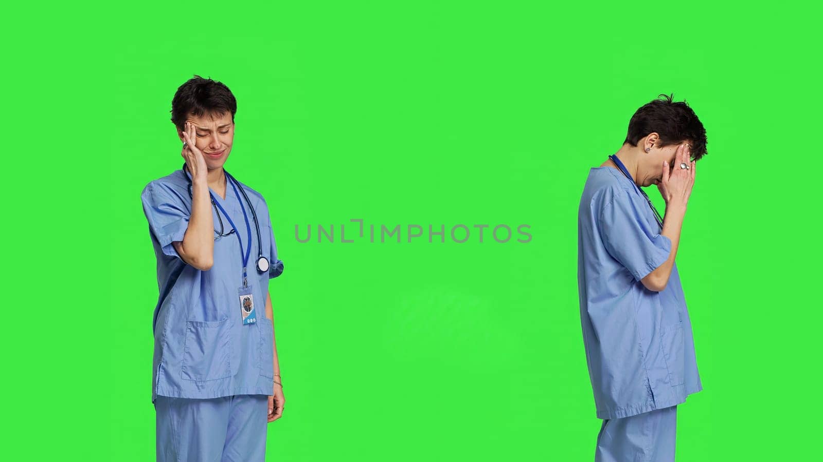 Unwell nurse suffering from a headache against greenscreen backdrop, wearing scrubs and feeling overworked at hospital. Medical assistant having a painful migraine, stress and burnout. Camera B.
