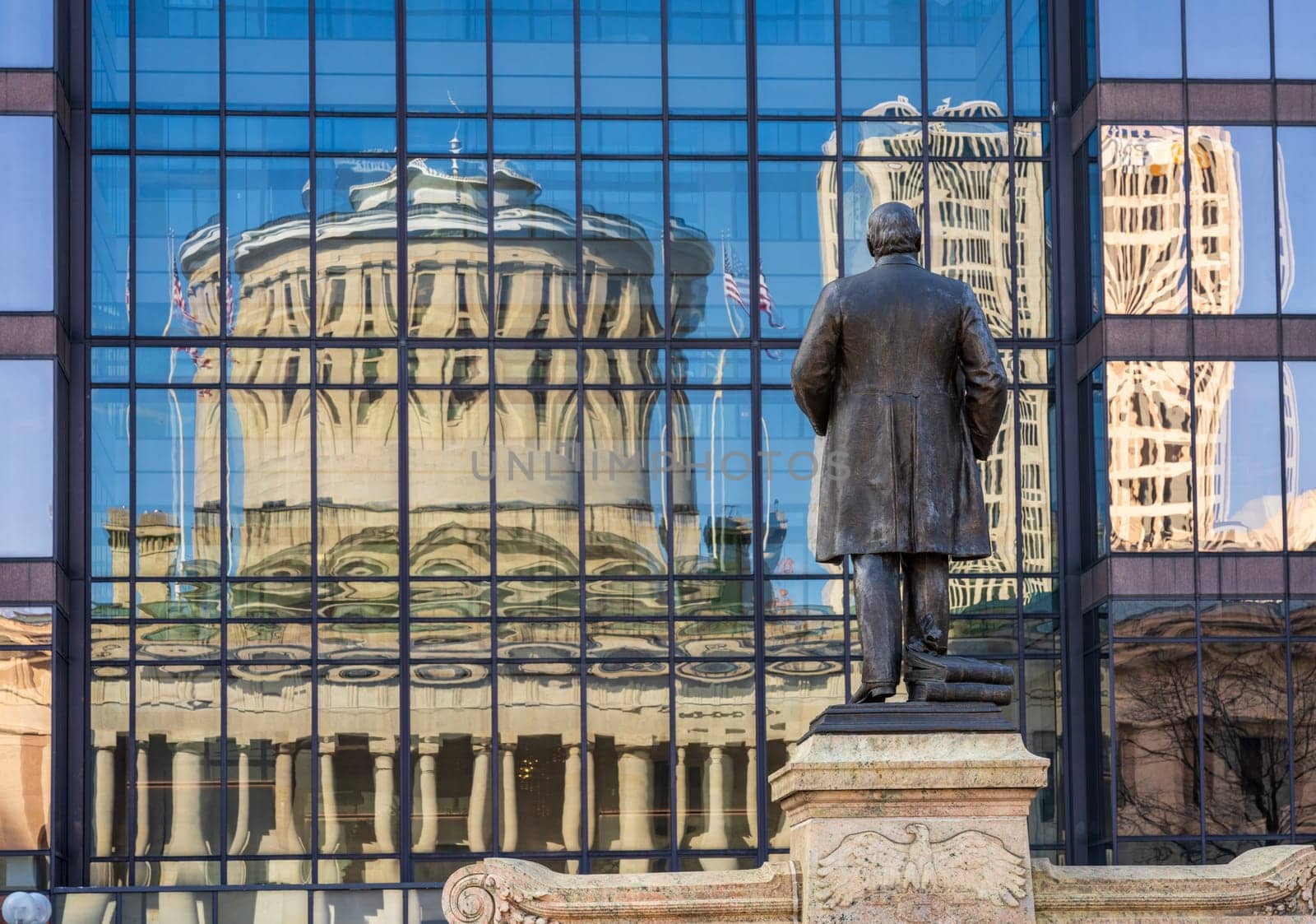 McKinley memorial in front of a reflection of the Ohio state Capitol building in the windows of an office building across the street in Columbus, OH