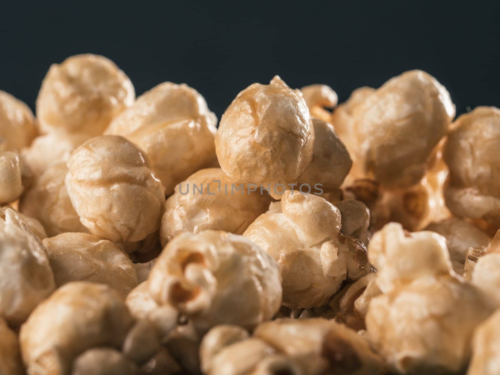 Close up view of caramel corn on black background