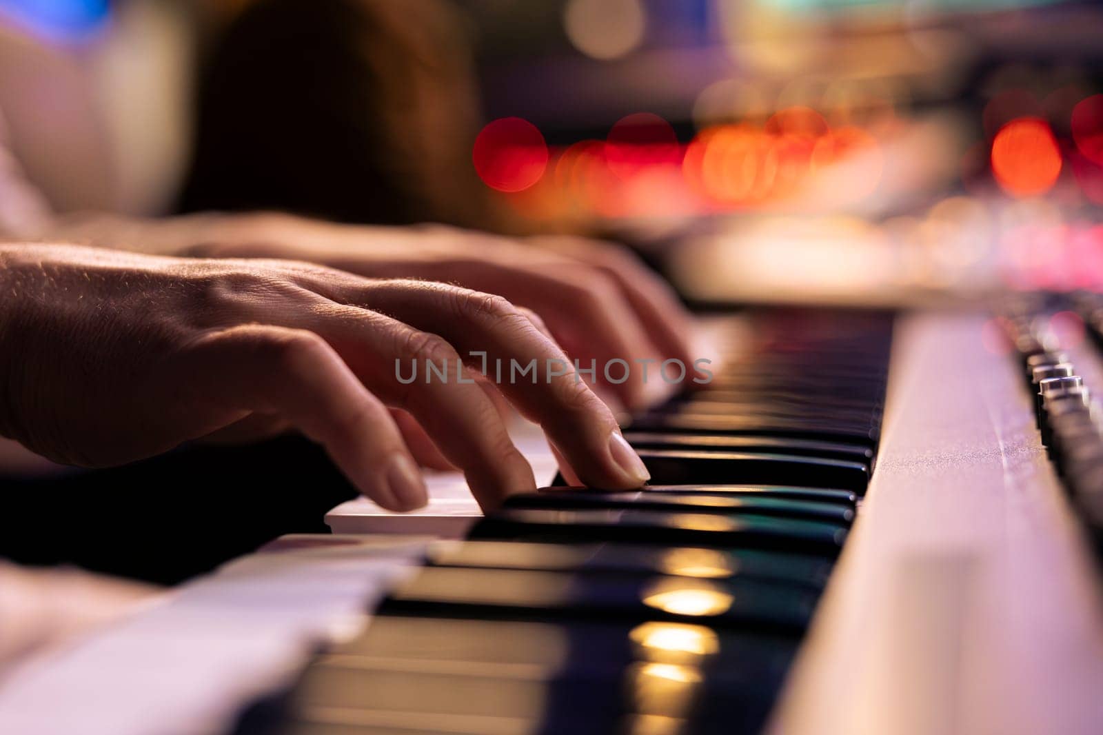 Musician playing electronic keyboard synthesizer in professional studio by DCStudio