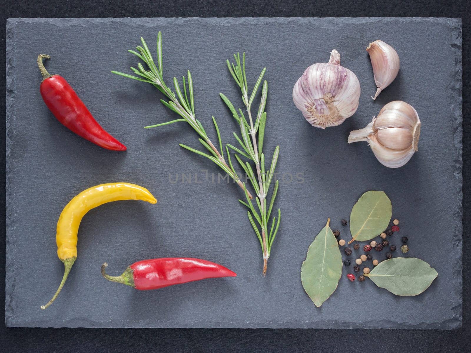 Herbs and spices over slate background. Top view or flat lay. Food background