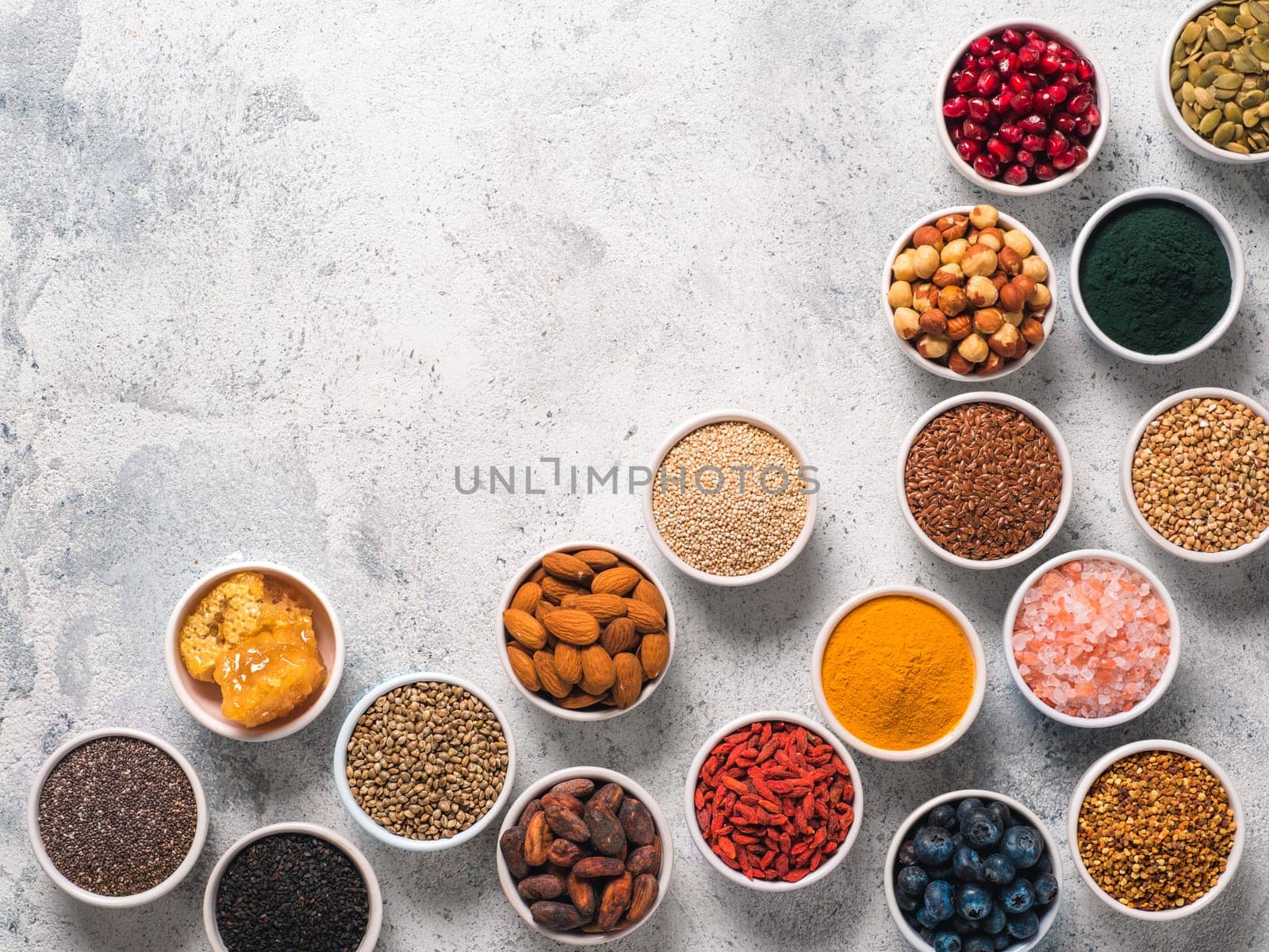 Various superfoods in bowl on gray background by fascinadora