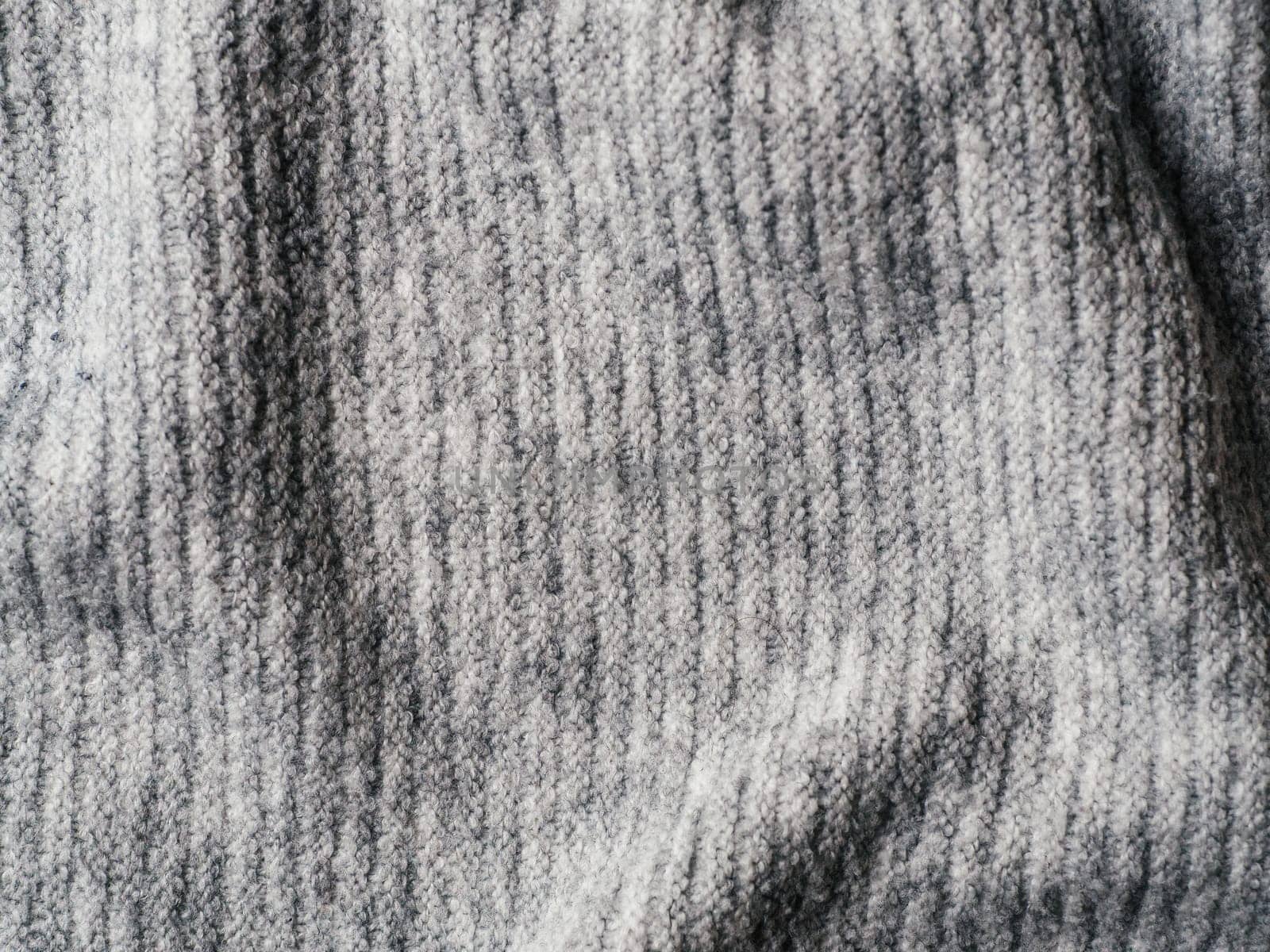 Gray sweater fabric texture. Clothes sweater background with folds