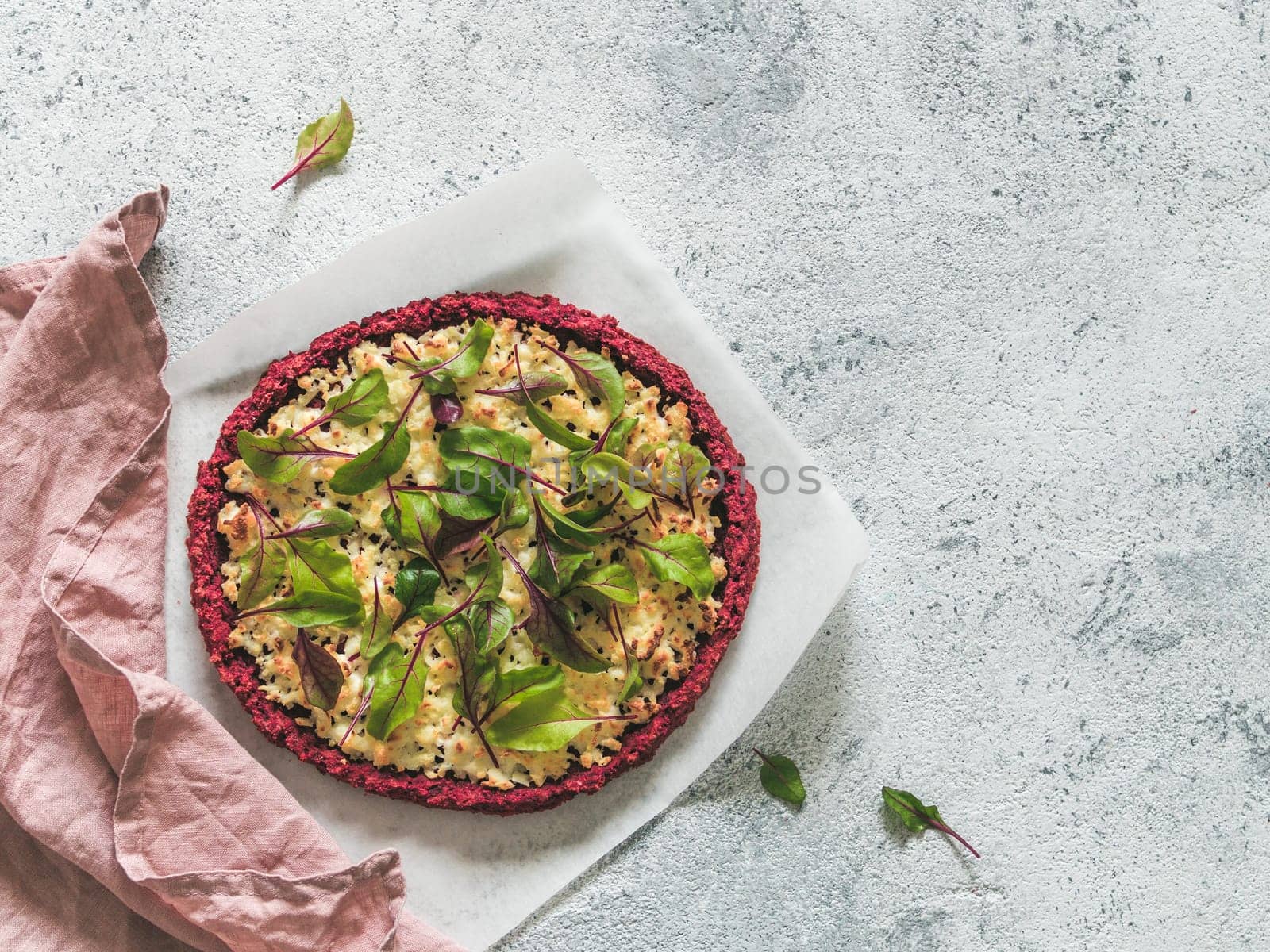 beetroot pizza crust with fresh swiss chard or mangold beetroot leaves.Ideas and recipes for healthy vegan snack.Egg-free pizza crust with chia seed and wholegrain brown rice flour.Copy space.Top view