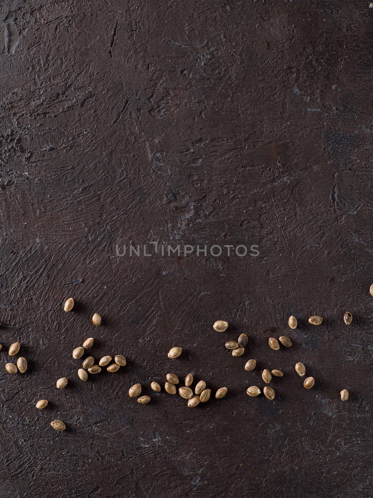 Hemp seeds on black top view, copy space by fascinadora