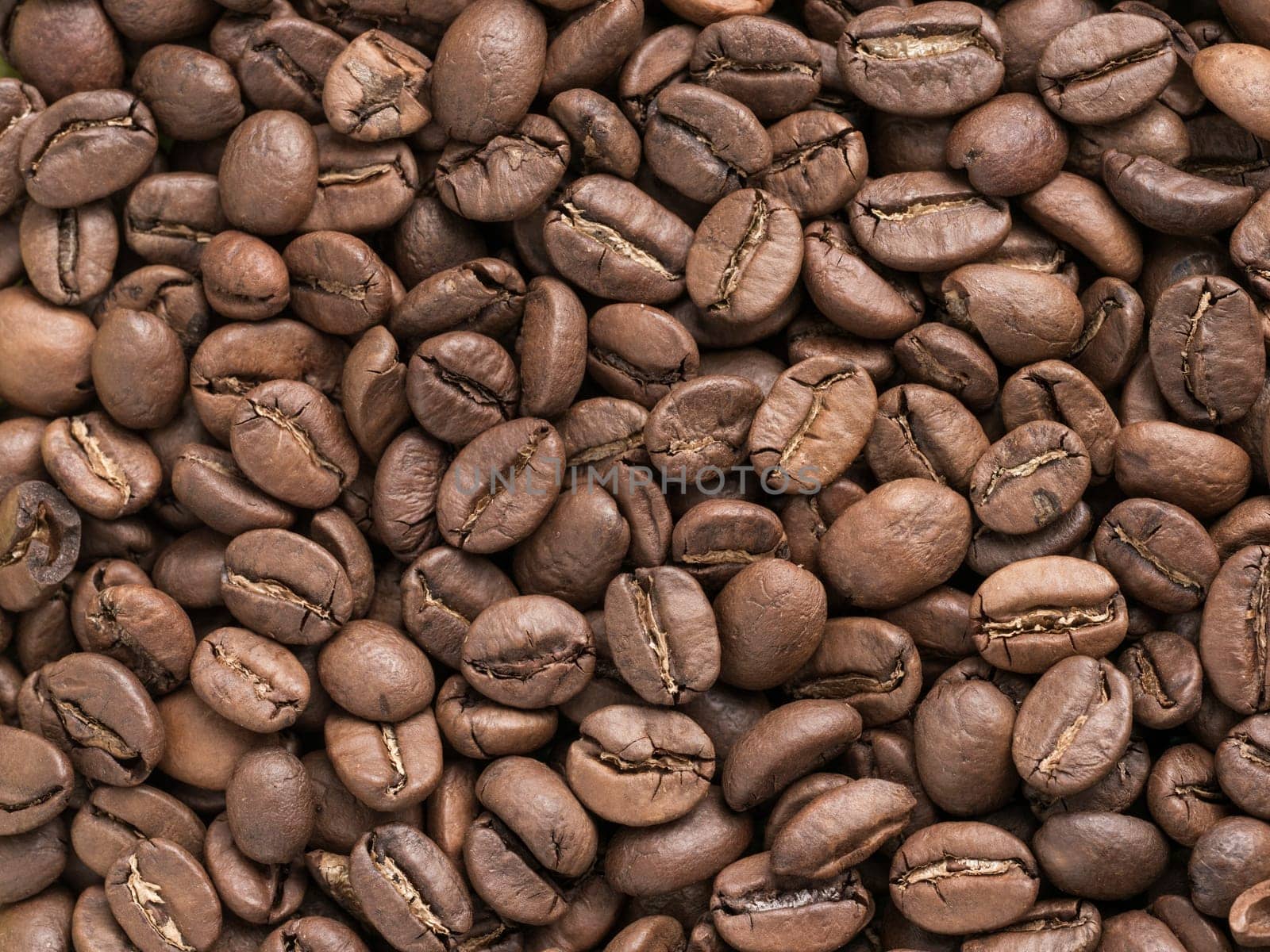 Coffee beans closeup background by fascinadora