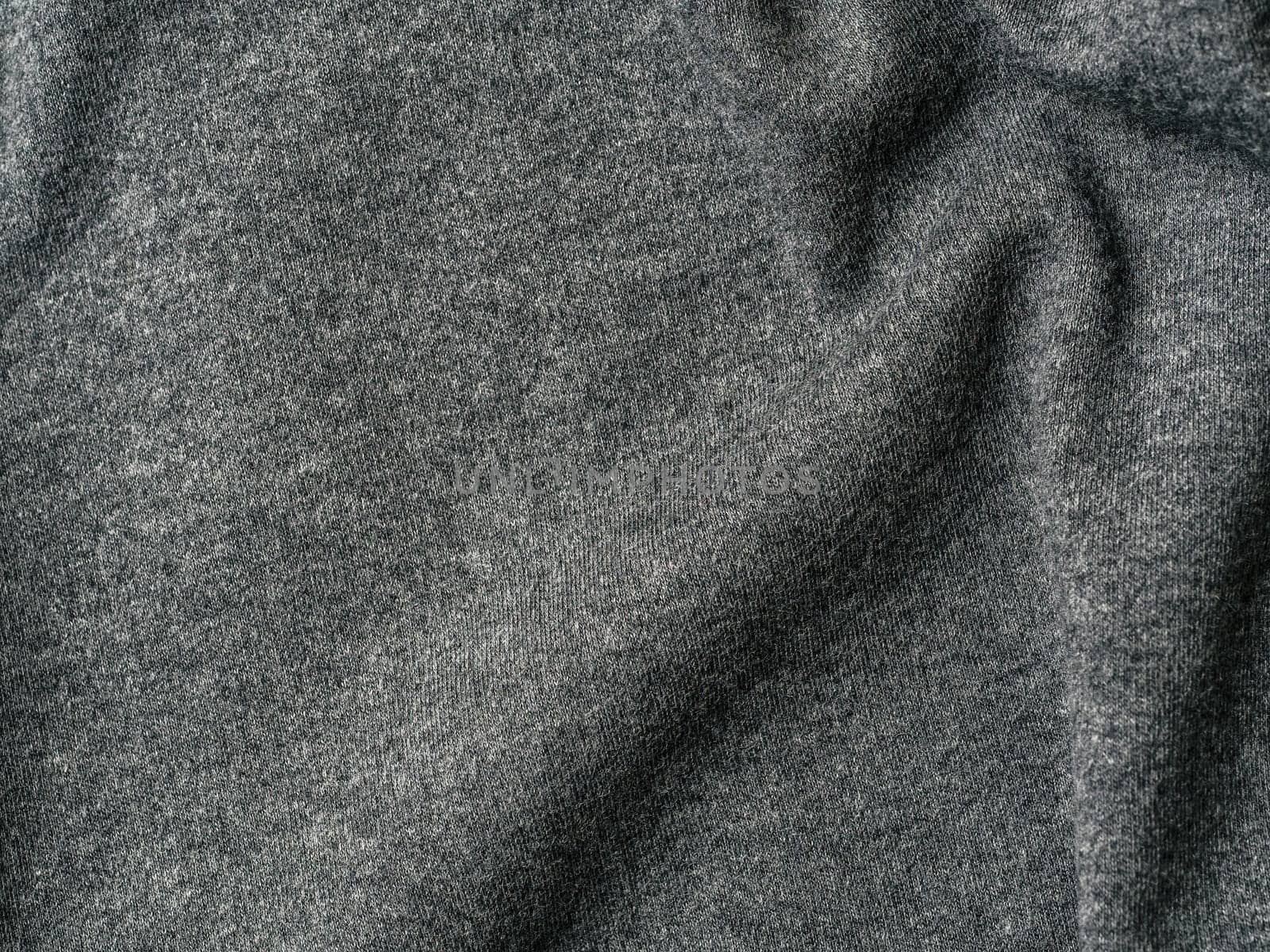 Gray cotton fabric texture. Clothes cotton jersey background with folds