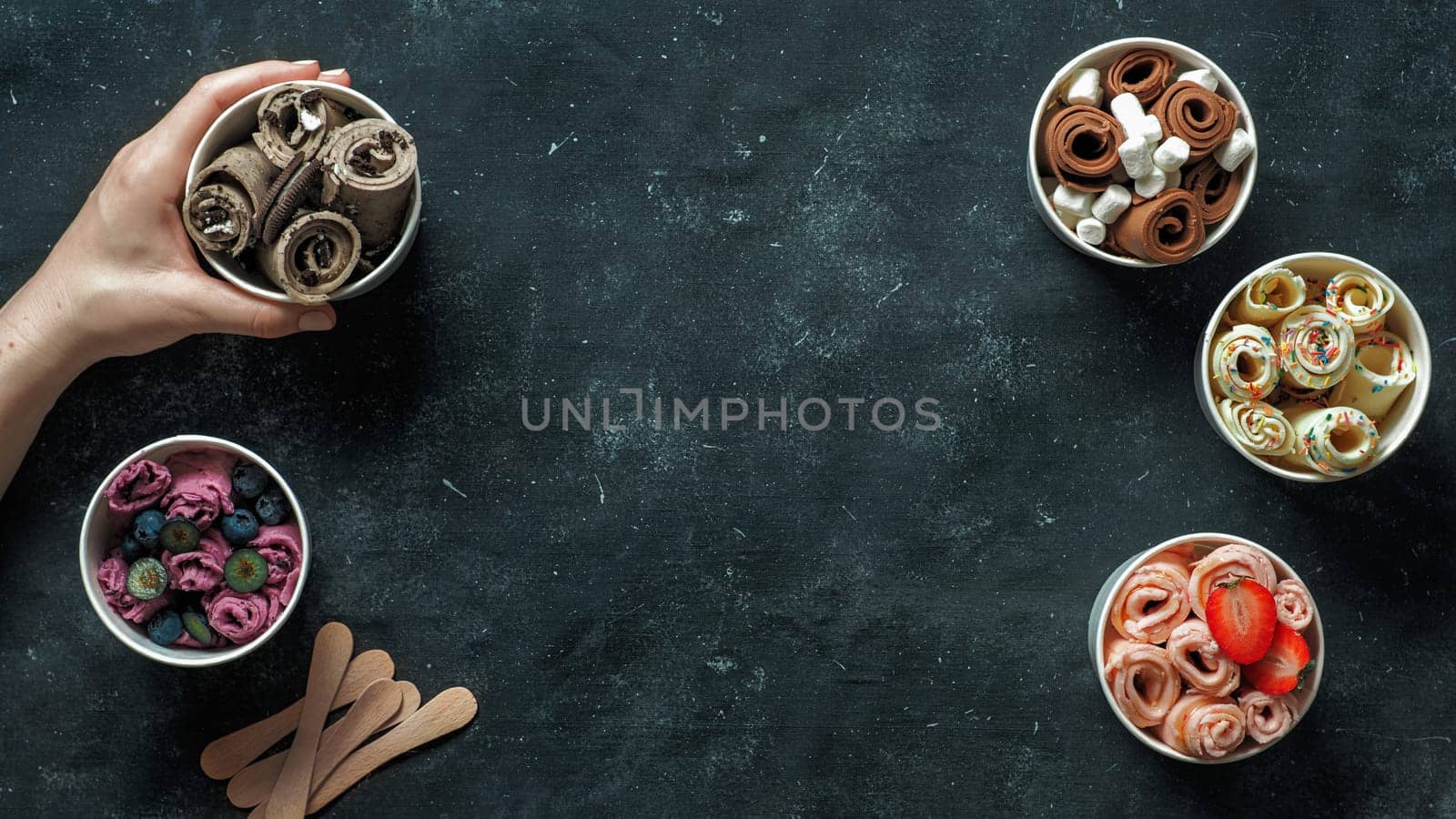rolled ice creams in cone cups on dark background by fascinadora