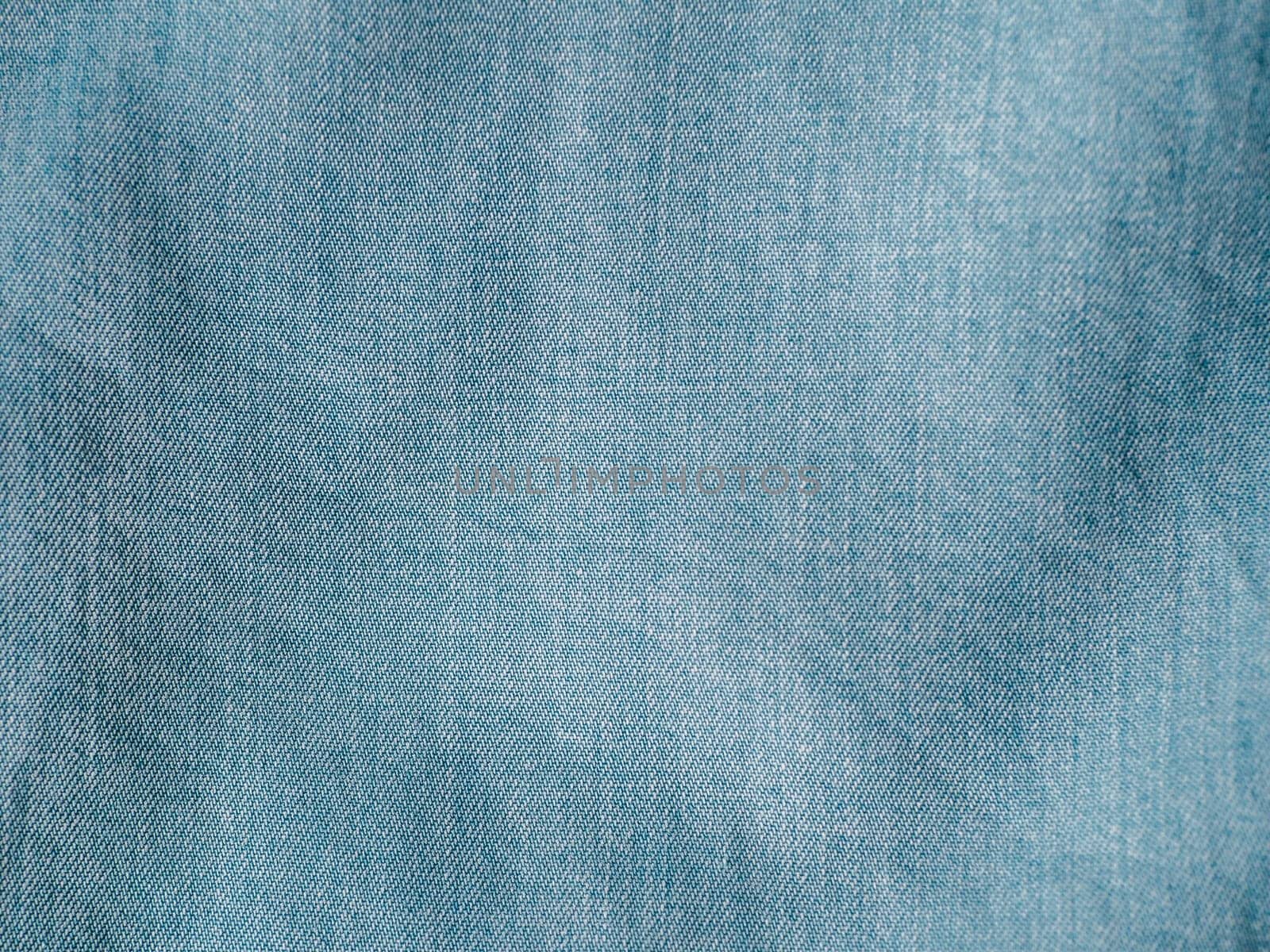 Modern soft jeans blouse texture close up. Lyocell or tencel pattern - modern natural cellulose fabric blue denim color. Can use for design or text. Copy space
