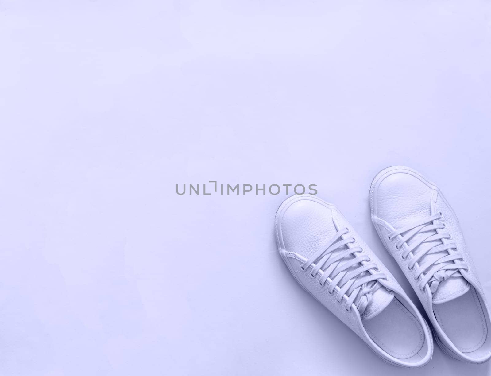 White sneakers on light background, copy space by fascinadora