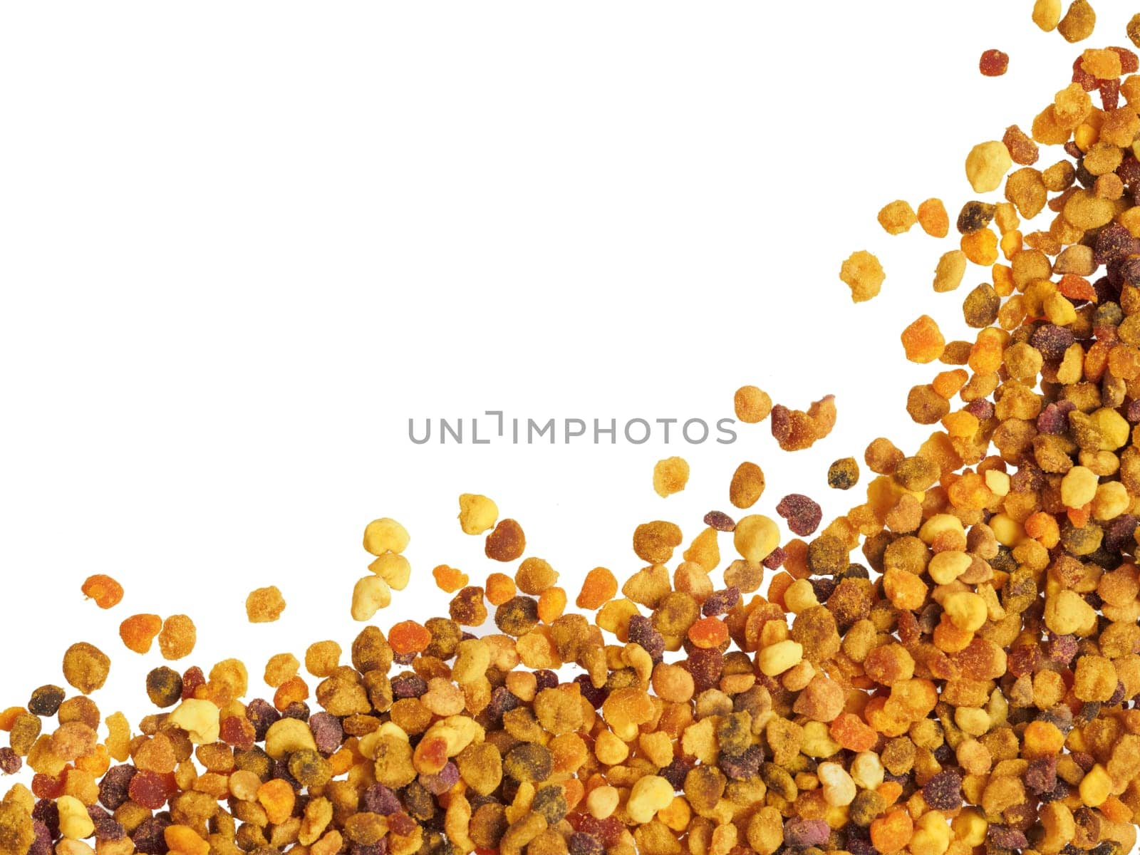 Extreme closeup view of bee pollen on white background. Isolated one edge. Copy space. Top view or flat lay.