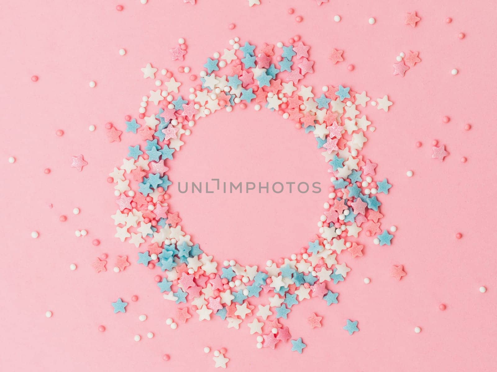 Sprinkles in round spahe on pink, copy space by fascinadora