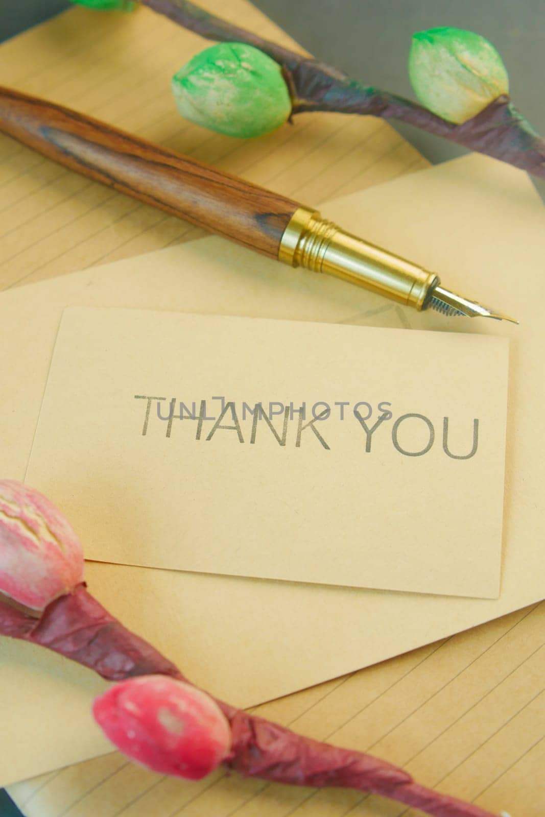 thank you message and envelope on wooden table.