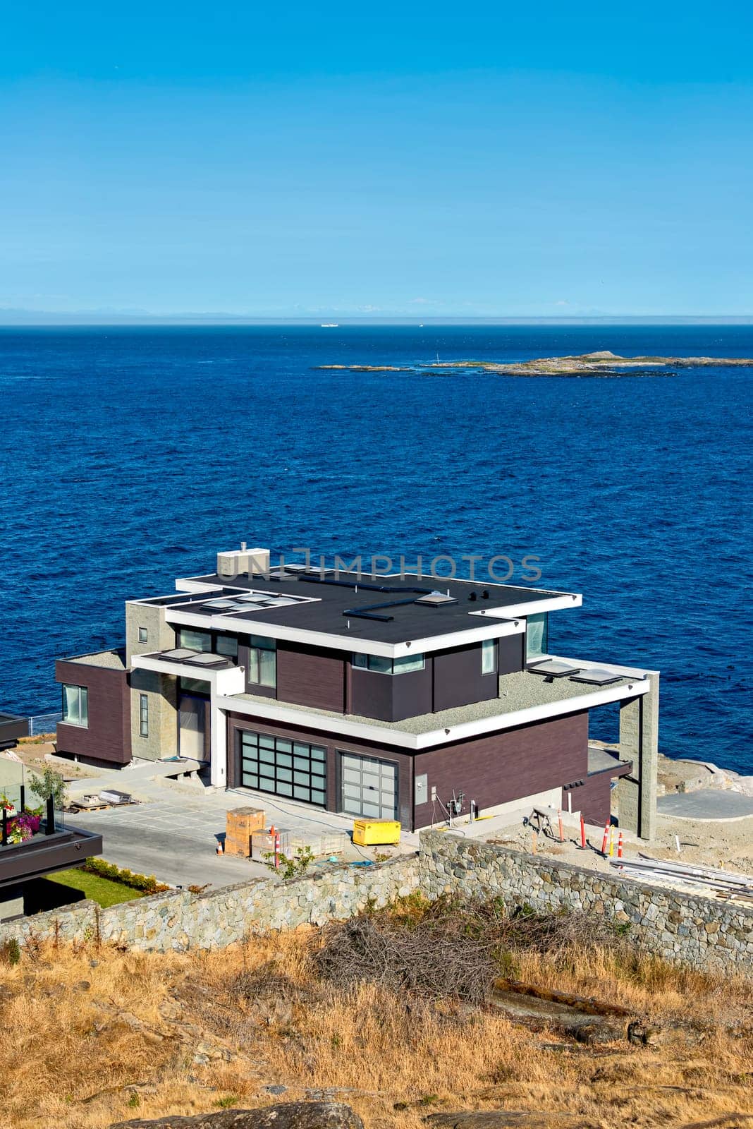 A perfect neighborhood. Luxury residential house under construction on Pacific ocean shore.
