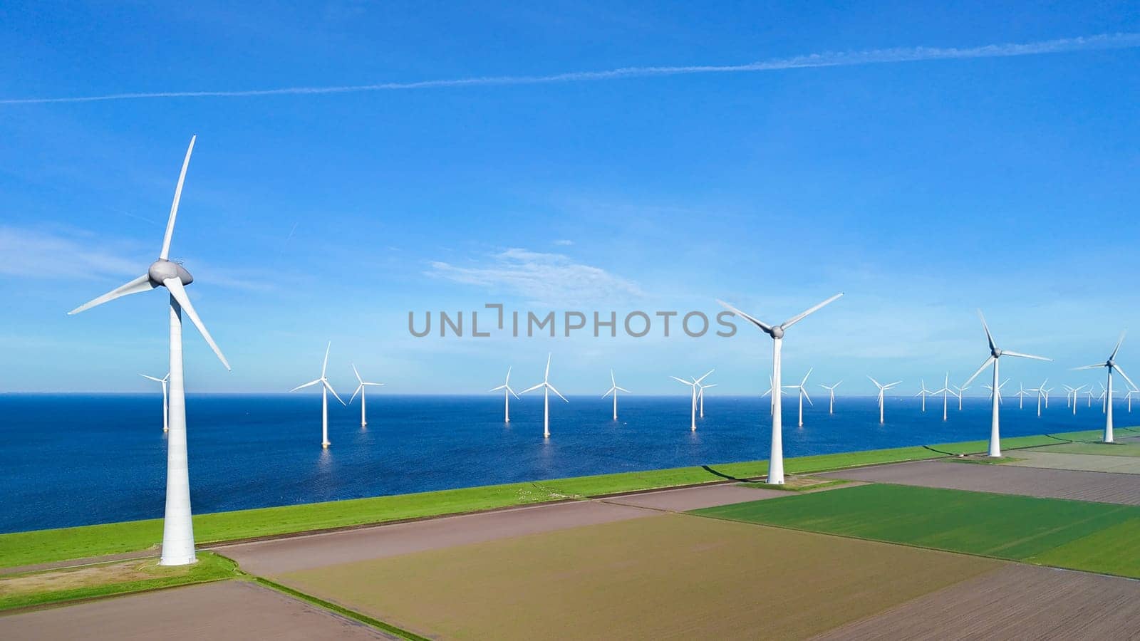 offshore windmill park and a blue sky, windmill park in the ocean. Netherlands Europe by fokkebok