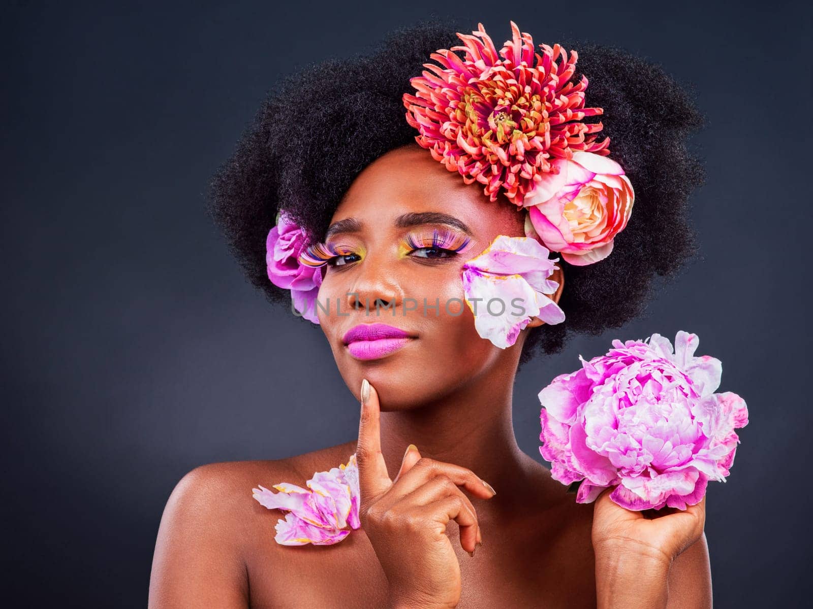 Flowers, idea and portrait of afro black woman in studio on dark background for cosmetics or editorial. Beauty, face makeup or thinking and young model with protea in hair for aesthetic wellness.