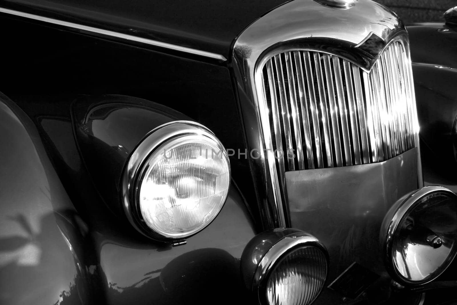 The front grill and headlight of the old beautiful car on the background copy space, card background by antoksena