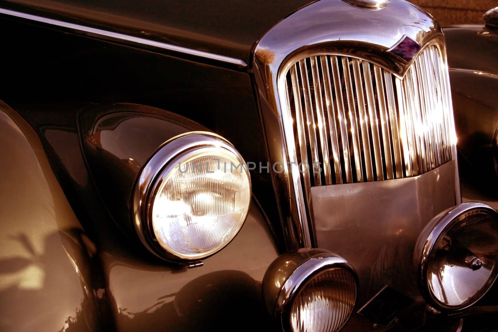 The front grill and headlight of the old beautiful car on the background copy space, card background, multimedia content creation