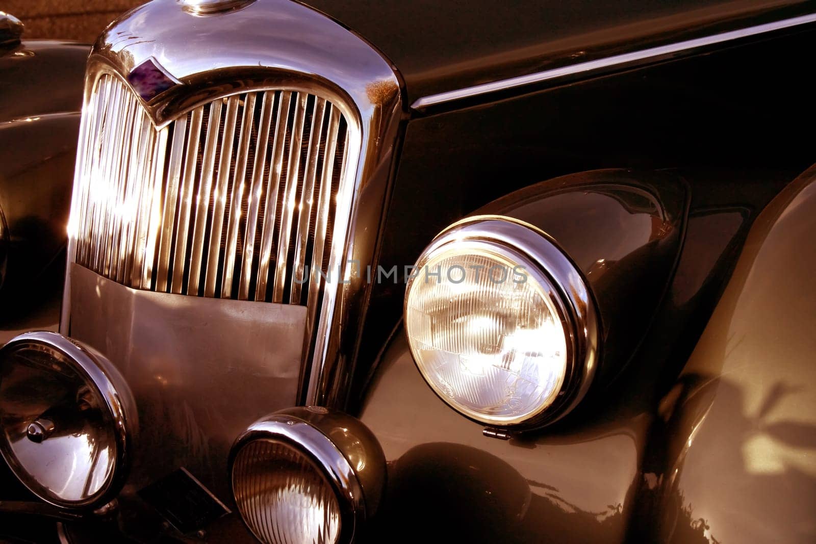 The front grill and headlight of the old beautiful car on the background copy space, card background by antoksena