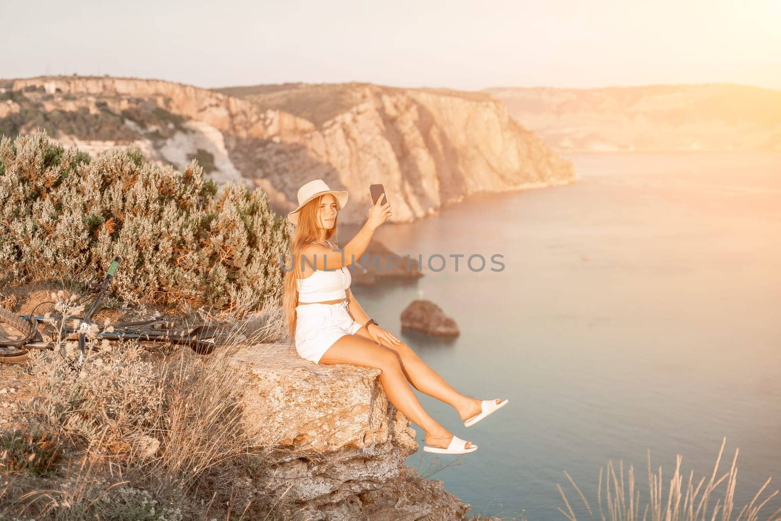 Selfie woman in cap and tank top making selfie shot mobile phone post photo social network outdoors on sea background beach people vacation lifestyle travel concept