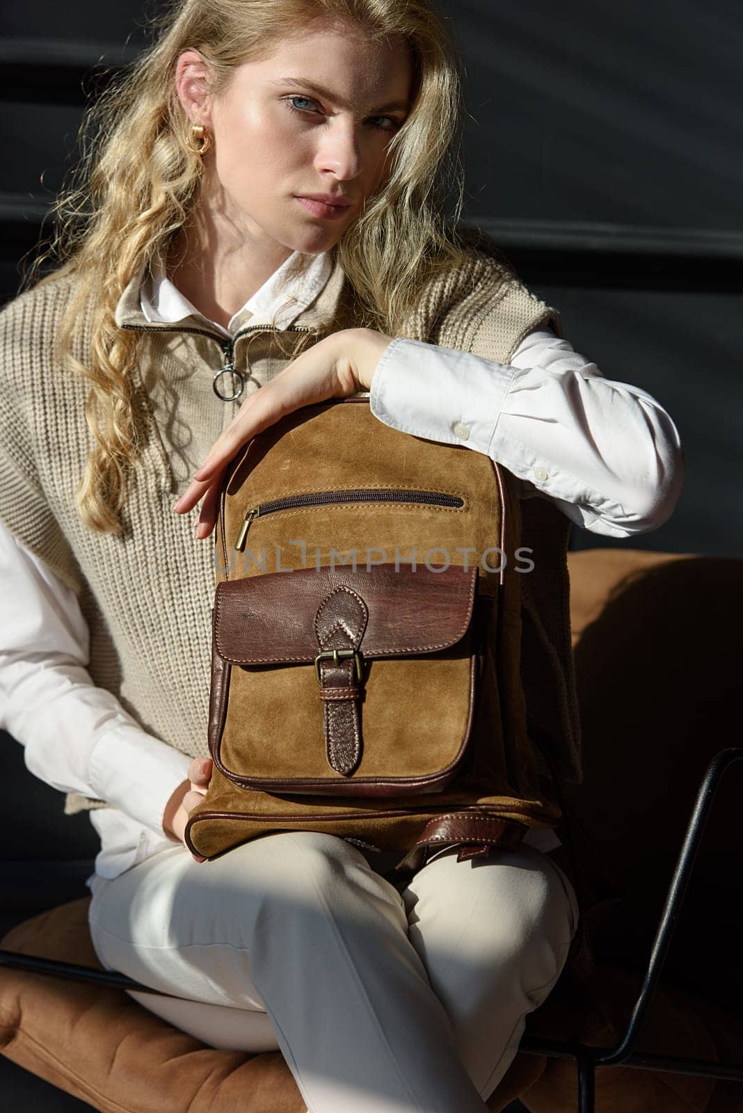 beautiful curly blond hair woman posing with a leather backpack by Ashtray25