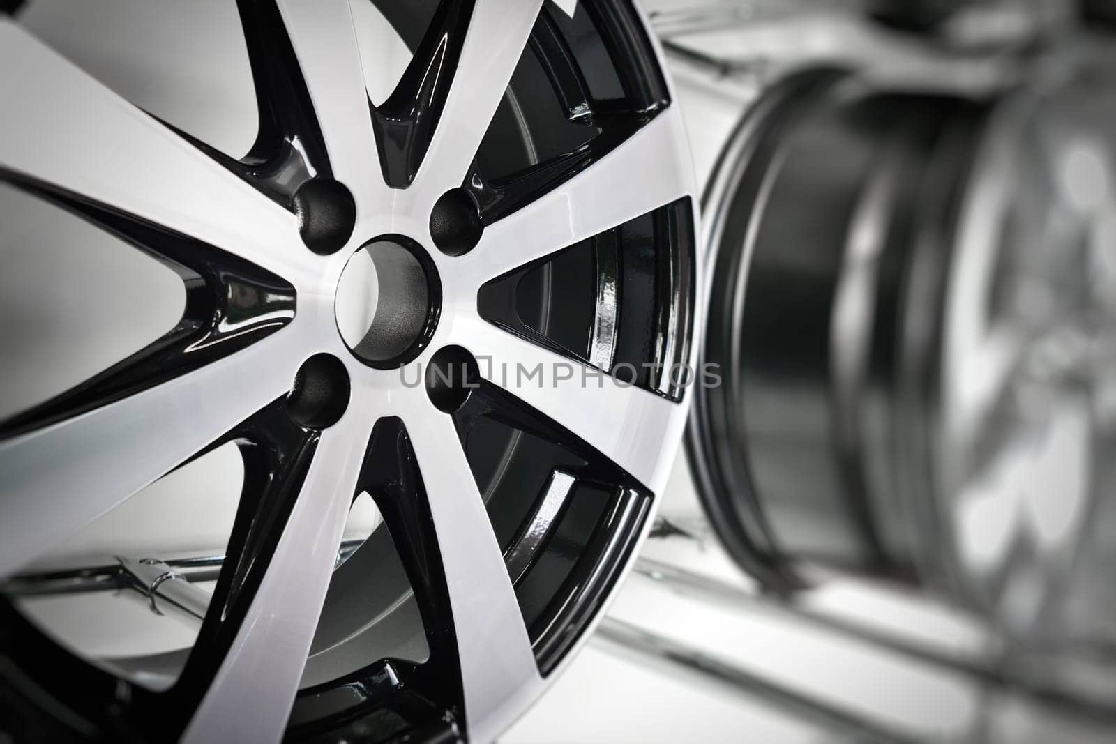 Close-up of light alloy wheels designed for passenger cars on display at a store stand by Rom4ek