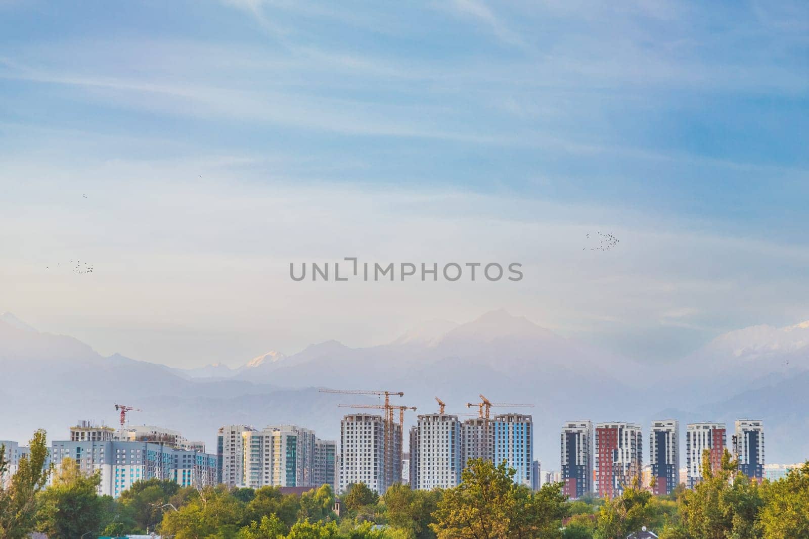 Dense development of the city of Almaty with high-rise residential complexes against the backdrop of mountains in a seismic zone by Rom4ek