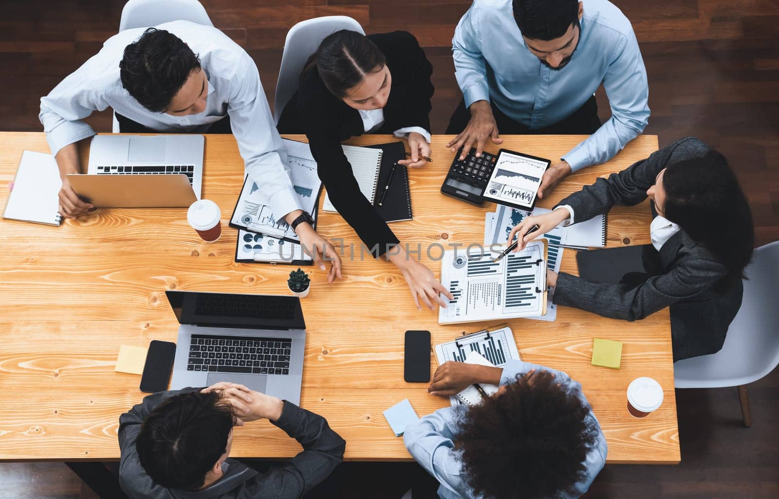 Top view multiracial analyst team use BI dashboard display on laptop screen, analyzing financial data for strategic decision. Fintech analyzes marketing indicators. Concord