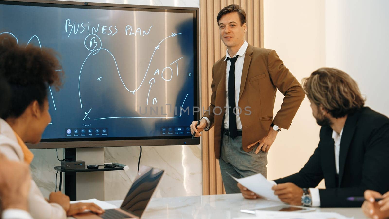 Presentation in ornamented meeting room with business professionals attending to project development drafting plan. Conference meeting with CEO present plan for investor and colleague with new project