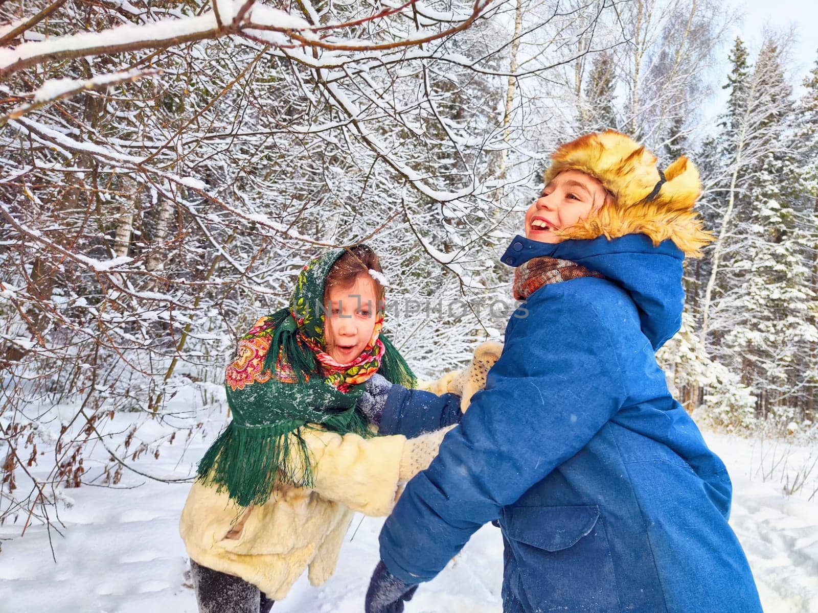 Two cute happy little cheerful children having fun in winter snow forest. Photo shoot in stylized clothes of USSR. Fur Hat with earflaps by keleny