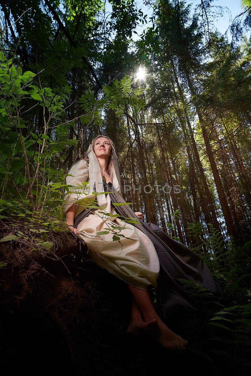 Beautiful seductive dryad. Pagan spirit of the forest. Portrait of beautiful dryad. Fairy who loves nature in beautiful green summer forest. Concept of environmental friendliness and caring for nature by keleny