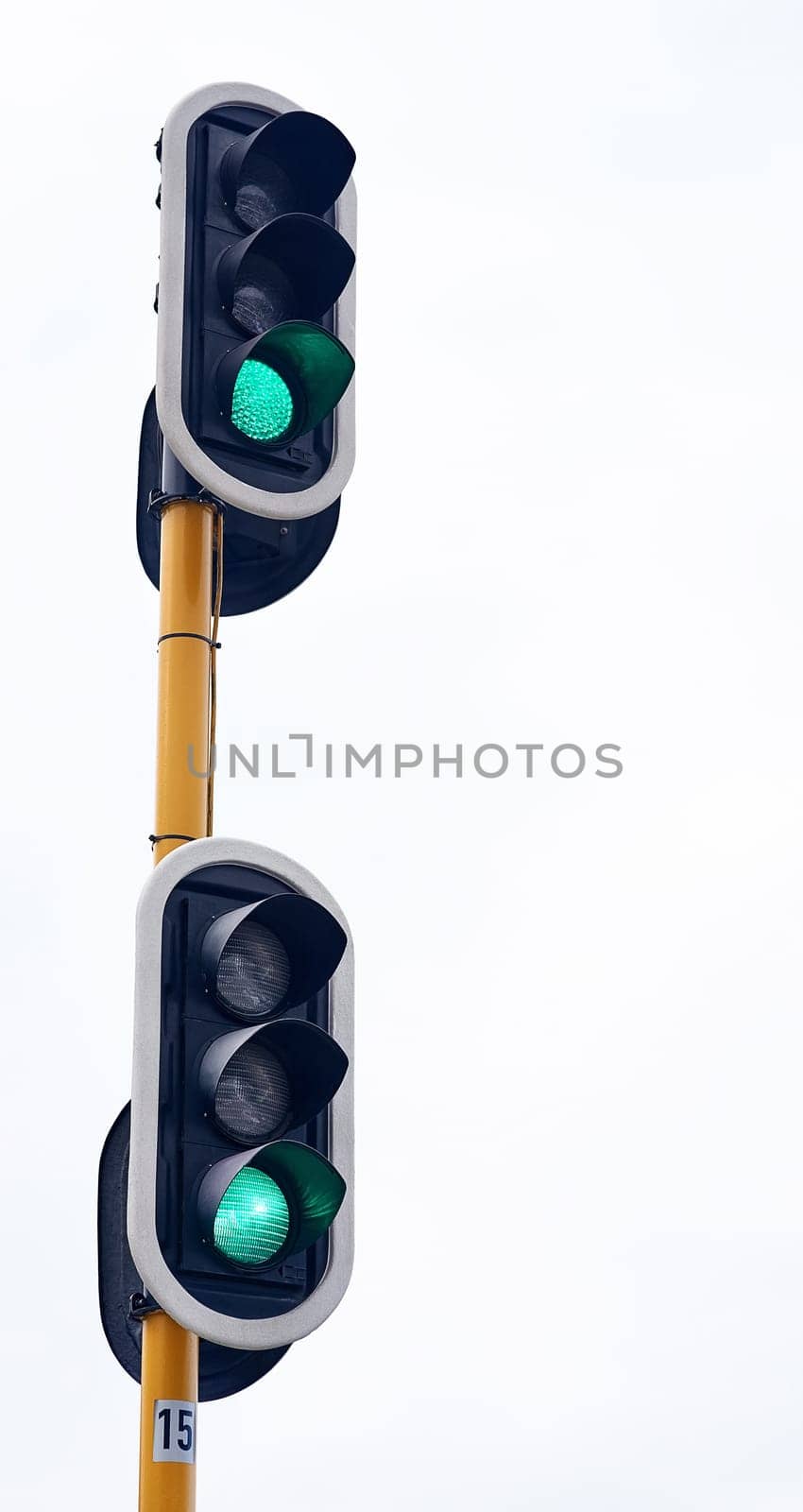 Traffic light, green and city intersection on street for go instruction, transportation or downtown. Road safety, commute and urban rules for traveling directions or infrastructure, driving or public.