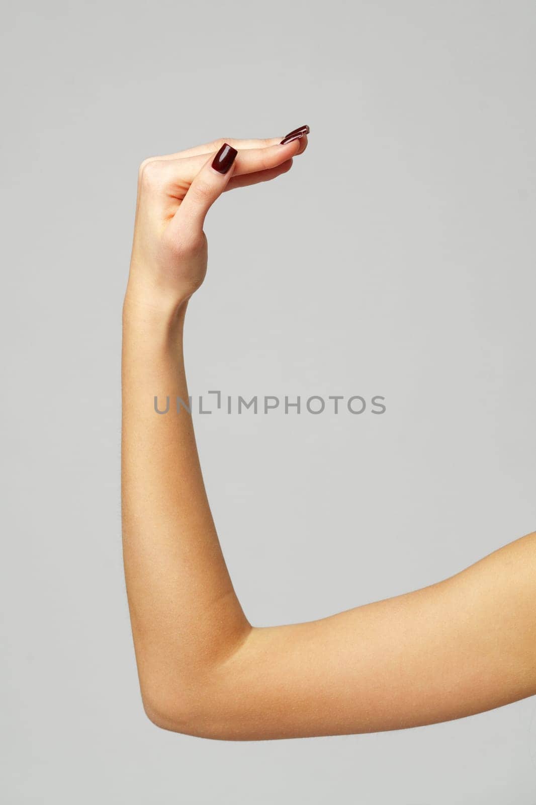 Young woman hand gesture on gray background close up