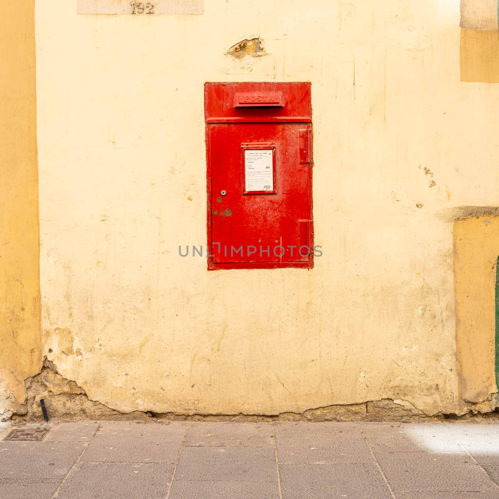 Valletta, Malta, April 03, 2024. Typical old red letterbox in a wall of the city center
