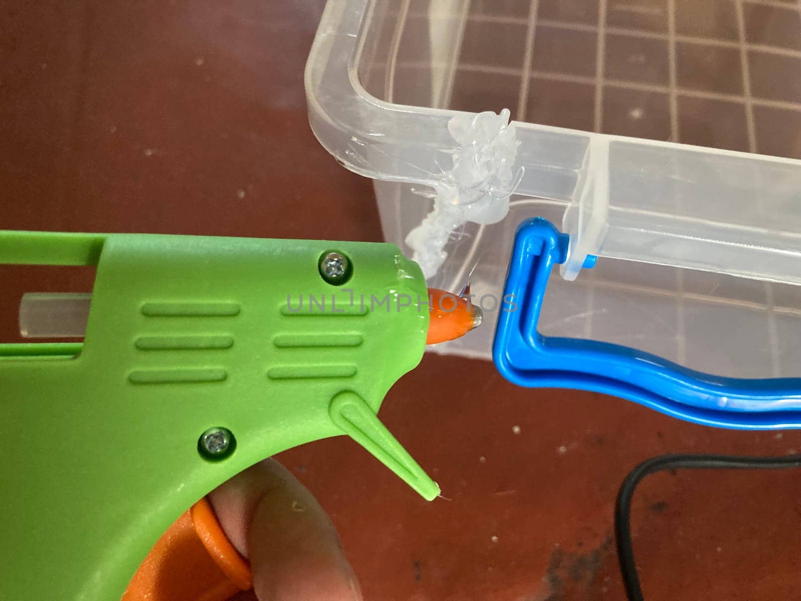 Gluing plastic containers using a the gun