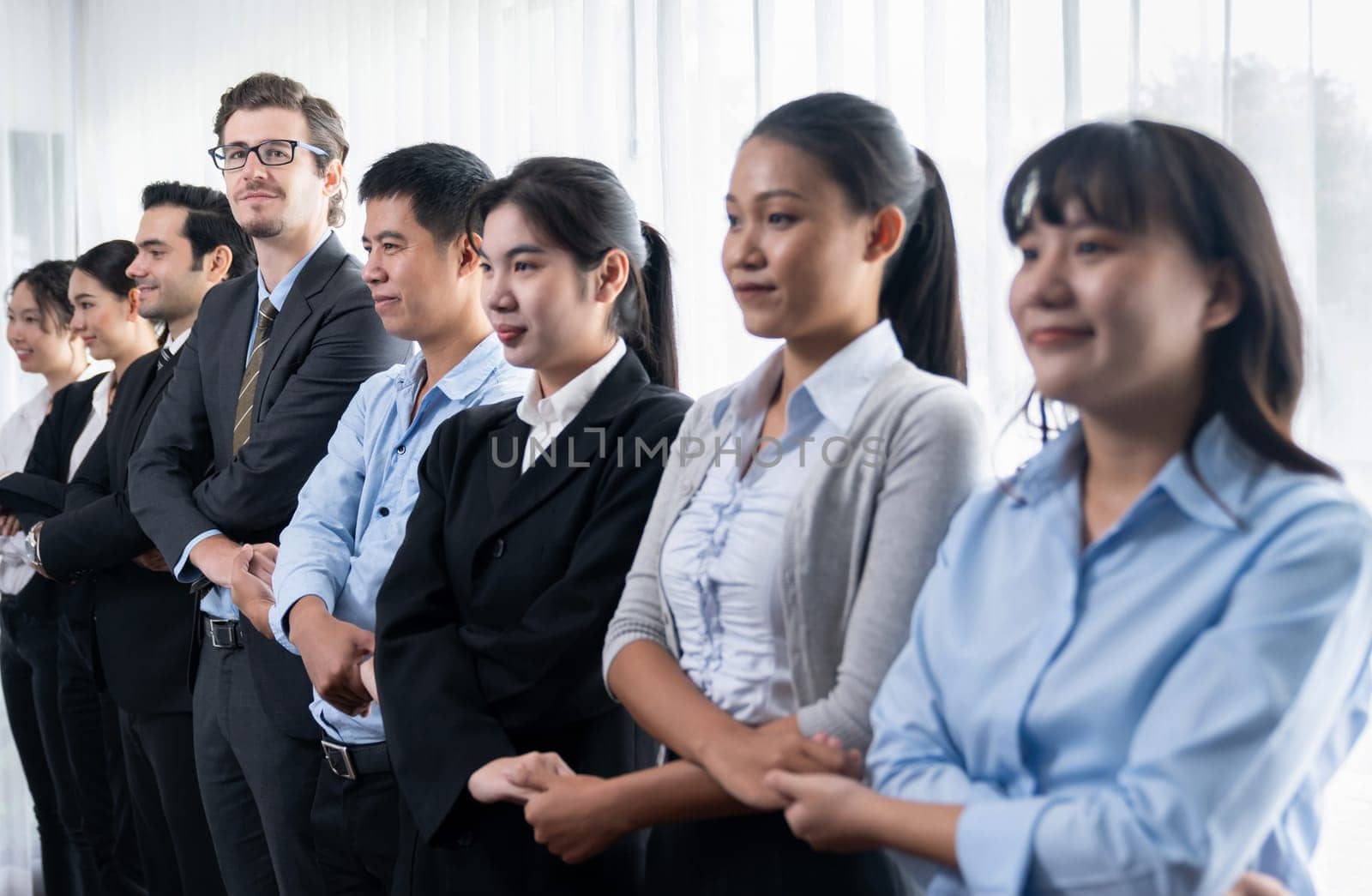 Business people joining hand together and standing in line. Meticulous by biancoblue