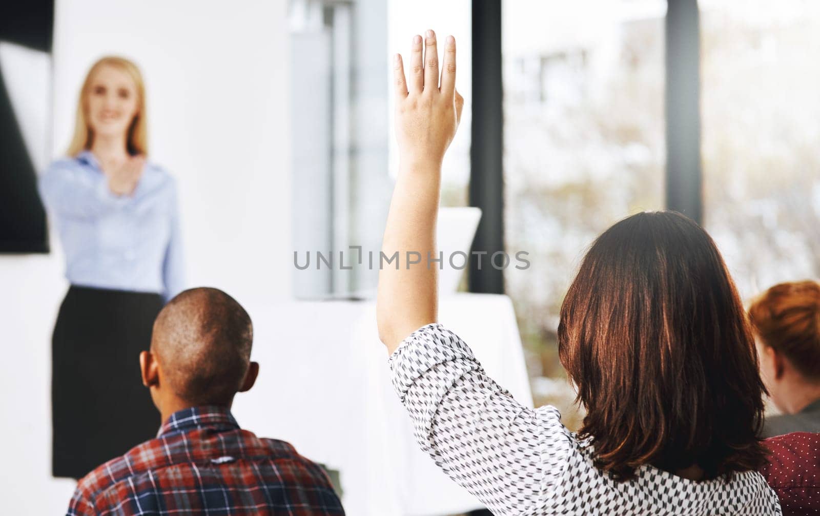 Presentation, question and business people at conference for corporate training, workshop and team building. Public speaking, communication or debate with audience, hand up at seminar or lecture.