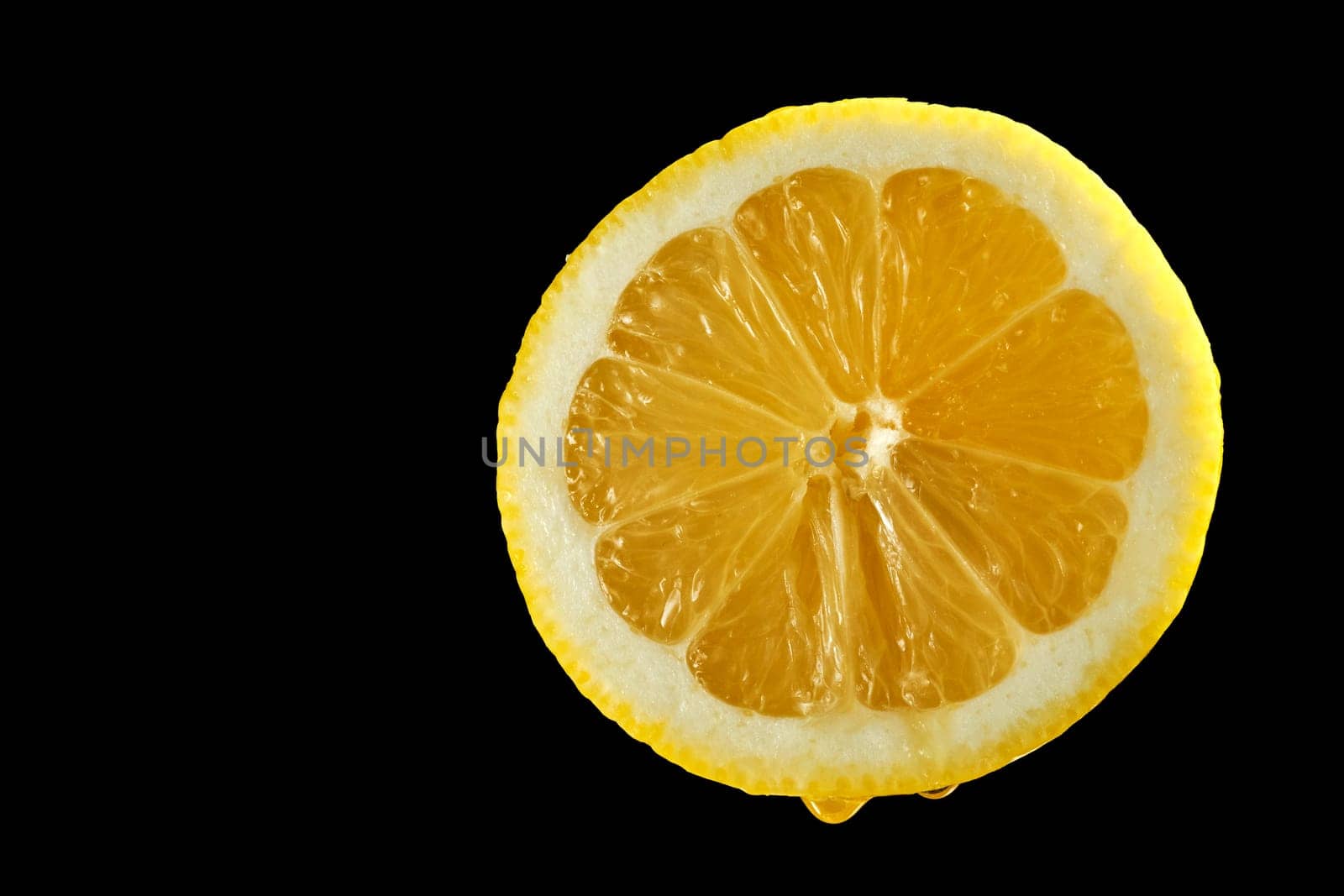 Closeup of half lemon with water droplets on black background by superstellar