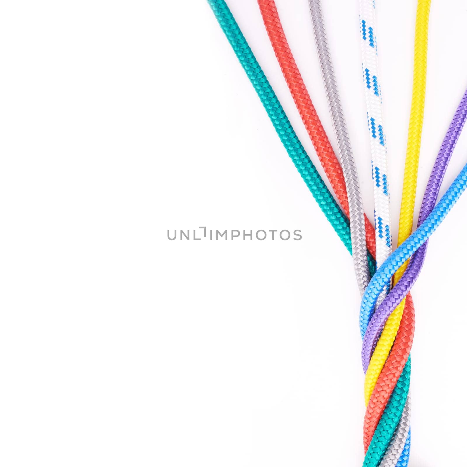 Rope, ties or connection of colorful knot or braid on white background in studio for security. Tools, cords and abstract unity of rainbow society with texture together for hiking, climbing or safety.