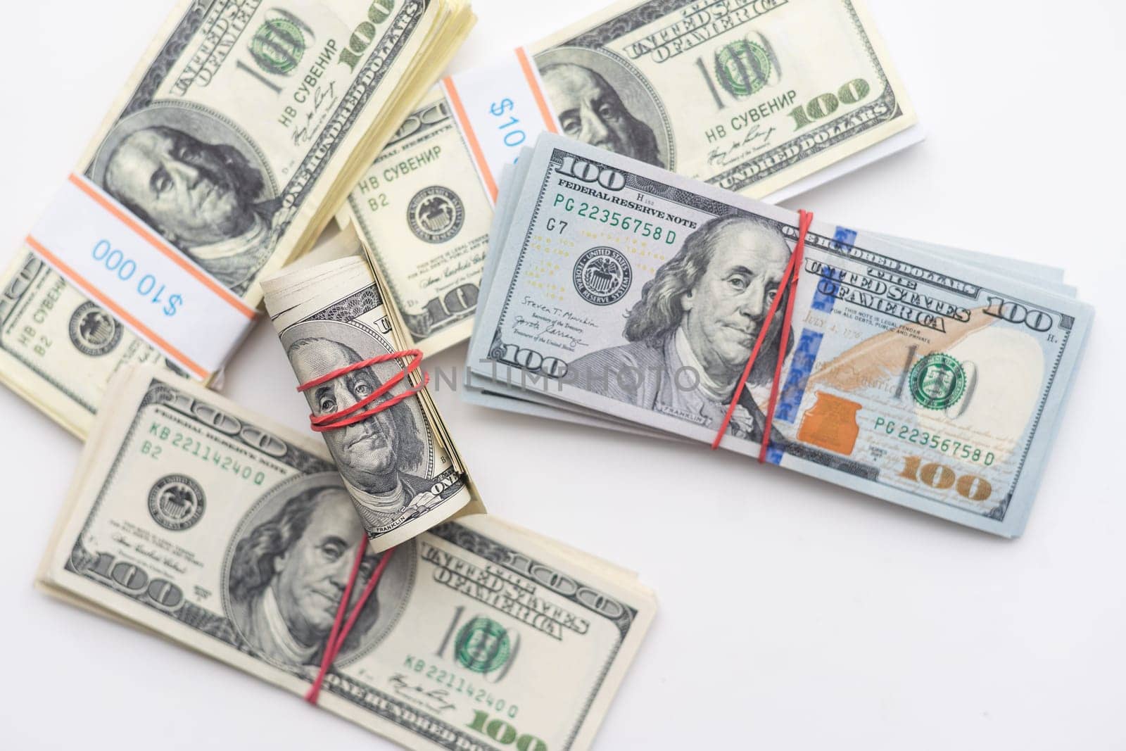 roles dollar notes in front of white background. High quality photo