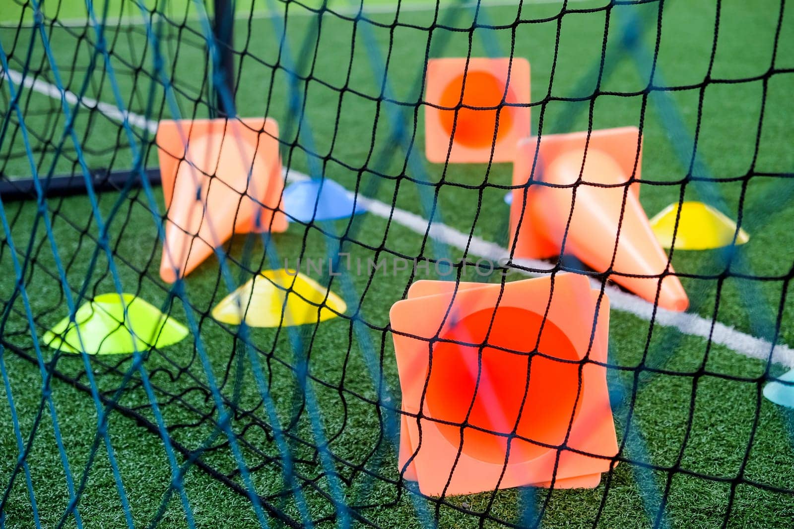 Soccer goal and cones on green artificial turf by ponsulak