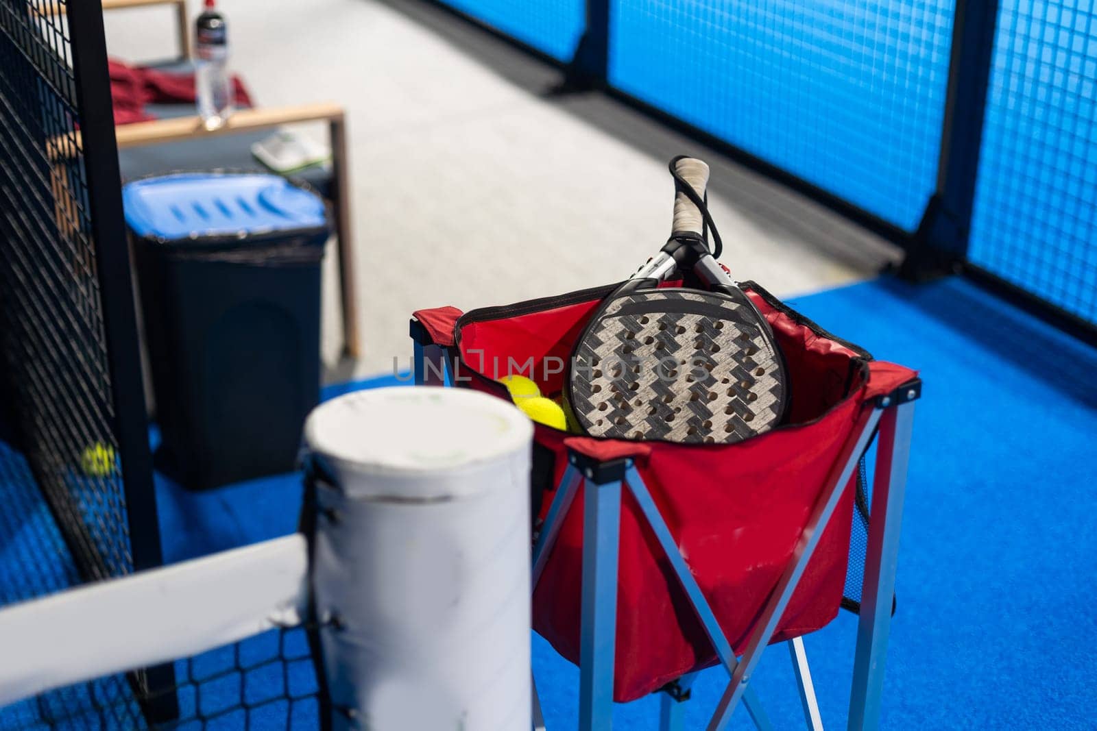Paddle ball on racket. Yellow paddle ball laying near racket. High quality photo