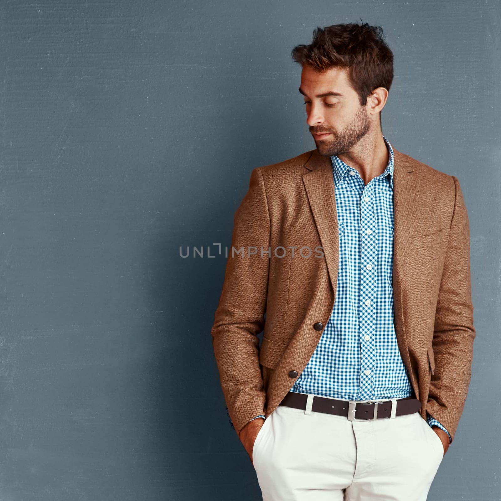 Relax, fashion and man with confidence, thinking and creative professional in studio. Business, trendy style and businessman on grey background with insight, opportunity and ideas in designer clothes by YuriArcurs