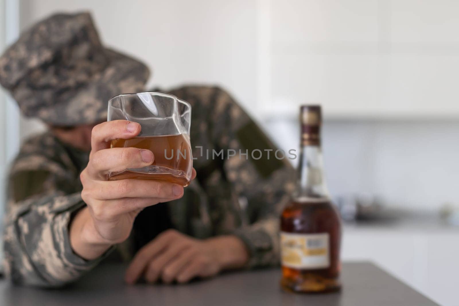 close up portrait of alcoholic wasted man sleeping drunk looking at whiskey glass avoiding temptation thinking of alcohol addiction , drinking abuse , alcoholism concept isolated on black background. High quality photo