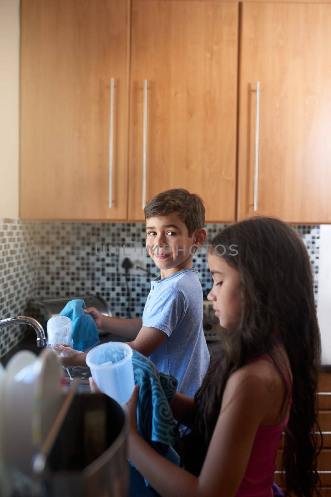 Boy, girl and cleaning in kitchen for development, children and learning teamwork in house. Kids, collaboration and happy together for helping, hygiene and spring cleaning in family home for care by YuriArcurs