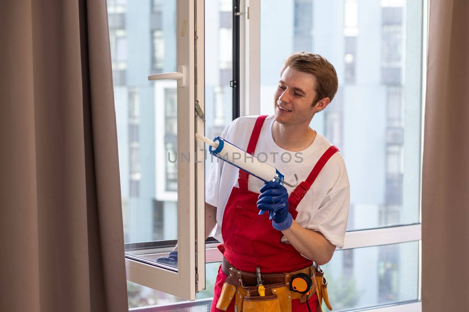 A repairman fixing windows in new apartment