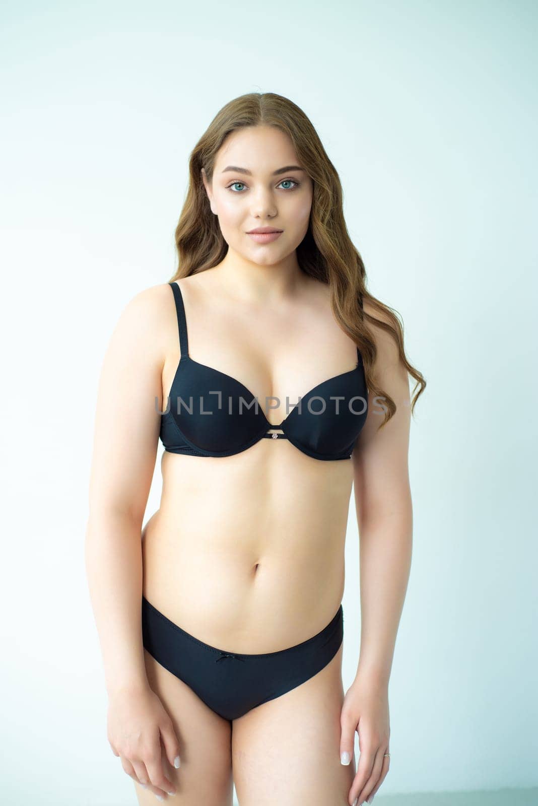 young woman with beautiful hair in black lingerie posing isolated on white background. Model test, snap, polaroid by OleksandrLipko