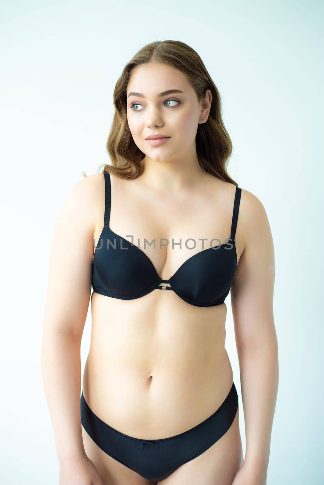 young woman with beautiful hair in black lingerie posing isolated on white background. Model test, snap, polaroid by OleksandrLipko