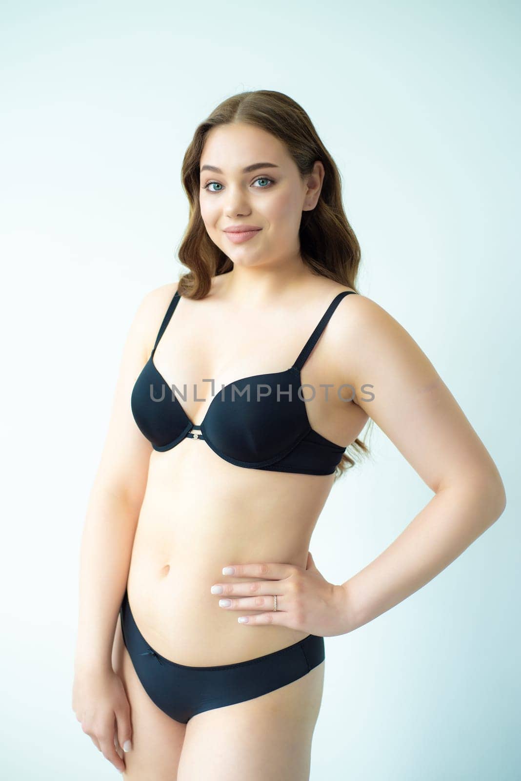 young woman with beautiful hair in black lingerie posing isolated on white background. Model test, snap, polaroid by OleksandrLipko