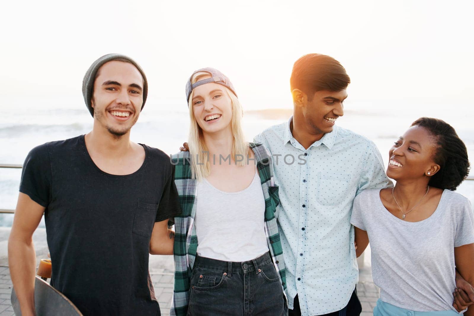 Date, diversity and smile with holiday at beach in summer or hot weather, together and support. Couple of friends, commitment and bonding for romance with soulmate, care and happy in boardwalk by YuriArcurs